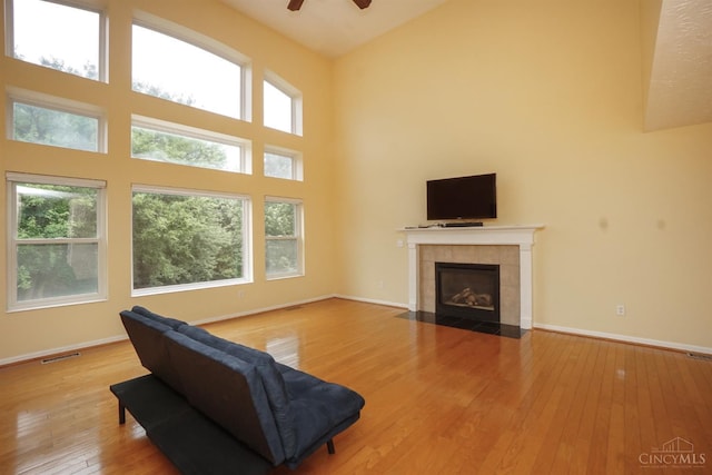 3779 Windyhollow Way, Mason, OH 45040 - living area with a towering ceiling, hardwood / wood-style flooring, a ceiling fan, a fireplace, and plenty of natural light