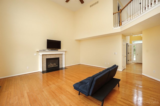 3779 Windyhollow Way, Mason, OH 45040 - living area featuring ceiling fan, hardwood / wood-style flooring, a high ceiling, and a tile fireplace