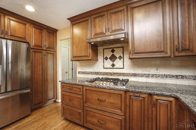 3779 Windyhollow Way, Mason, OH 45040 - kitchen featuring stainless steel appliances, under cabinet range hood, dark stone countertops, and light wood-style floors