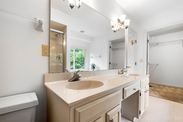 3057 Fox Den Ln, Anderson Twp, OH 45244 - full bathroom with double vanity, a spacious closet, an enclosed shower, and a chandelier