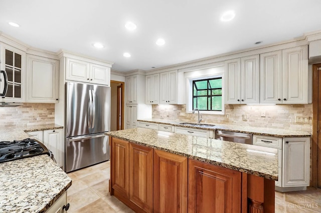 3057 Fox Den Ln, Anderson Twp, OH 45244 - kitchen with stainless steel appliances, decorative backsplash, a kitchen island, light stone countertops, and glass insert cabinets