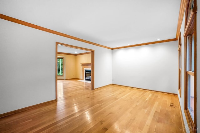3057 Fox Den Ln, Anderson Twp, OH 45244 - spare room featuring light wood-style floors, ornamental molding, recessed lighting, and a tiled fireplace