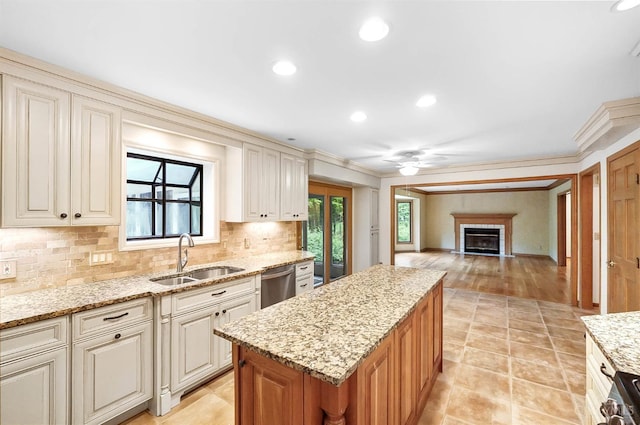 3057 Fox Den Ln, Anderson Twp, OH 45244 - kitchen with stainless steel appliances, decorative backsplash, a fireplace, crown molding, and a ceiling fan