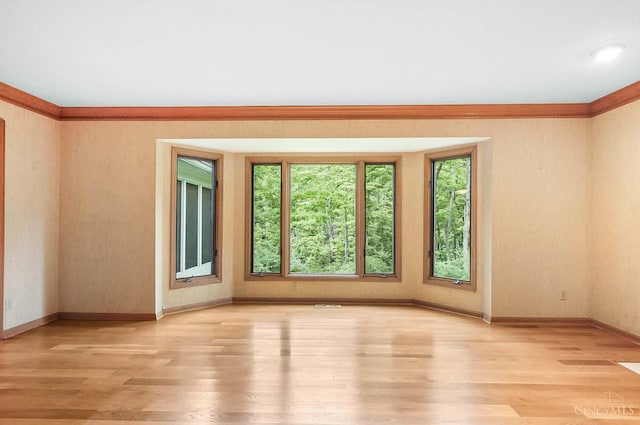 3057 Fox Den Ln, Anderson Twp, OH 45244 - unfurnished room featuring healthy amount of natural light, light wood-style floors, and crown molding