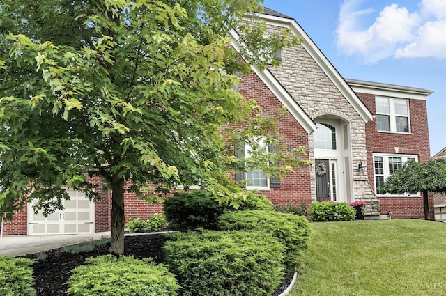 10285 Plantation Pointe Dr, Symmes Twp, OH 45140 - view of front of home with a front yard, brick siding, stone siding, concrete driveway, and a garage