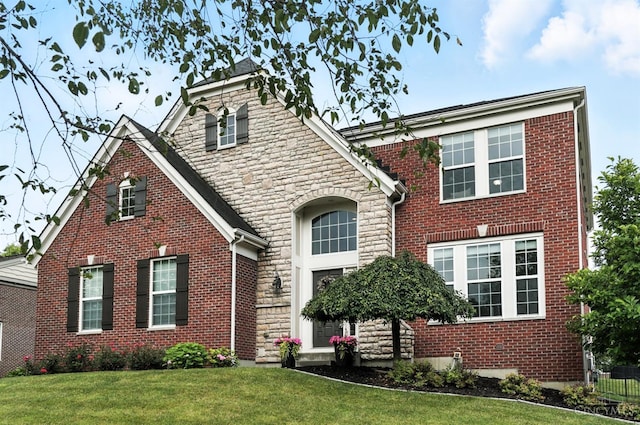 10285 Plantation Pointe Dr, Symmes Twp, OH 45140 - view of front facade featuring stone siding, a front yard, and brick siding