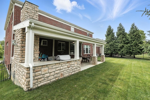 10285 Plantation Pointe Dr, Symmes Twp, OH 45140 - back of property with a patio area, a chimney, brick siding, and stone siding