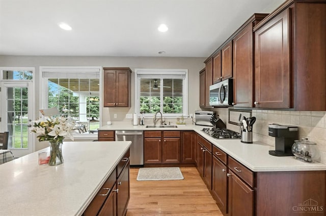 10285 Plantation Pointe Dr, Symmes Twp, OH 45140 - kitchen featuring appliances with stainless steel finishes, light wood-type flooring, light countertops, recessed lighting, and tasteful backsplash