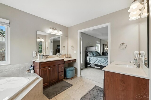 10285 Plantation Pointe Dr, Symmes Twp, OH 45140 - full bathroom with two vanities, a garden tub, tile patterned flooring, and connected bathroom
