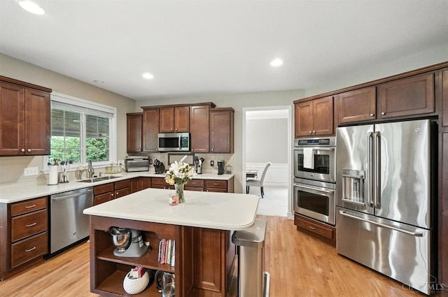 10285 Plantation Pointe Dr, Symmes Twp, OH 45140 - kitchen featuring stainless steel appliances, light wood-type flooring, light countertops, recessed lighting, and a kitchen island