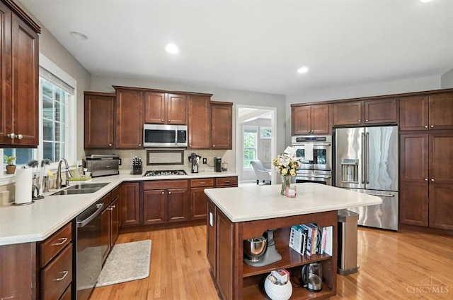 10285 Plantation Pointe Dr, Symmes Twp, OH 45140 - kitchen featuring stainless steel appliances, open shelves, light wood finished floors, light countertops, and backsplash