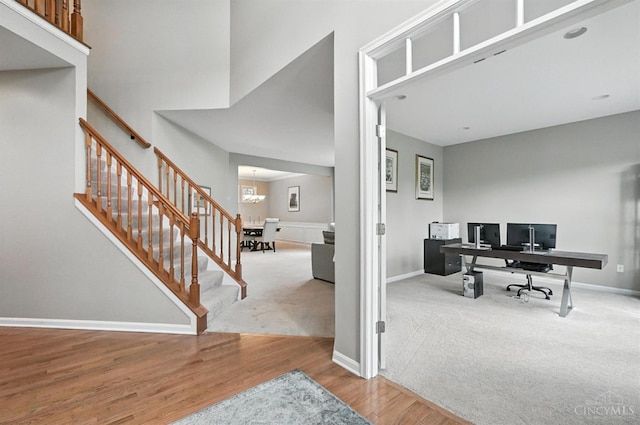10285 Plantation Pointe Dr, Symmes Twp, OH 45140 - carpeted home office with wood finished floors and a towering ceiling