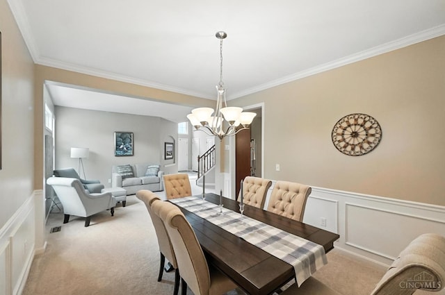 10285 Plantation Pointe Dr, Symmes Twp, OH 45140 - dining room featuring a chandelier, crown molding, carpet, a decorative wall, and wainscoting