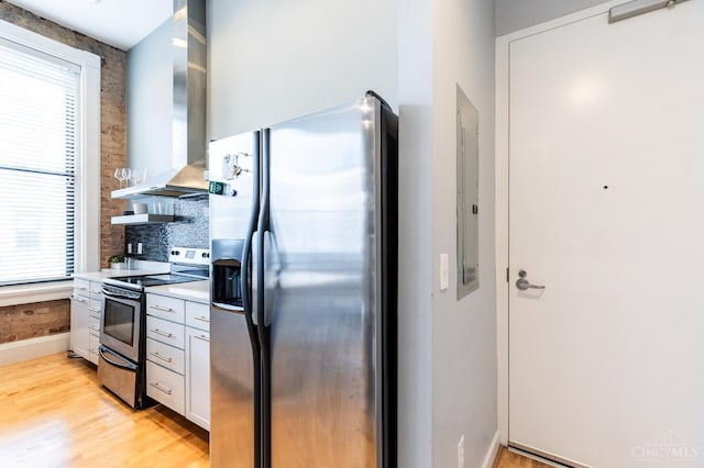 1201 Vine St Unit C, Cincinnati, OH 45202 - kitchen with stainless steel appliances, wall chimney exhaust hood, healthy amount of natural light, and light wood-style floors