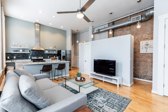 1201 Vine St Unit C, Cincinnati, OH 45202 - living area with ceiling fan, light wood-type flooring, and a high ceiling