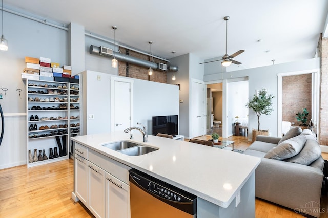 1201 Vine St Unit C, Cincinnati, OH 45202 - kitchen featuring stainless steel dishwasher, open floor plan, light countertops, a ceiling fan, and a high ceiling