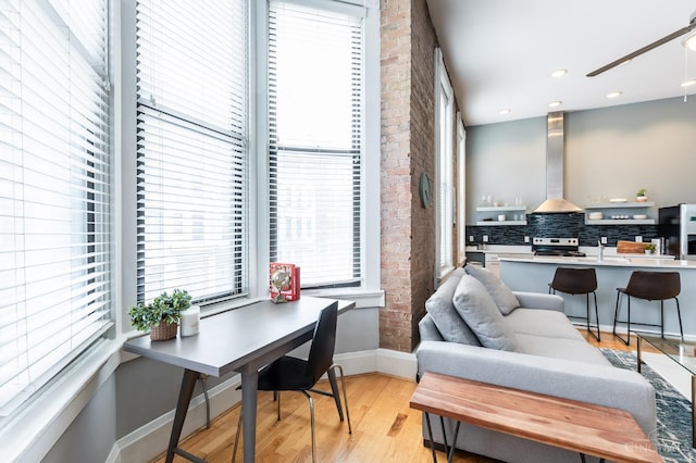 1201 Vine St Unit C, Cincinnati, OH 45202 - home office with plenty of natural light, light wood-type flooring, a ceiling fan, and brick wall