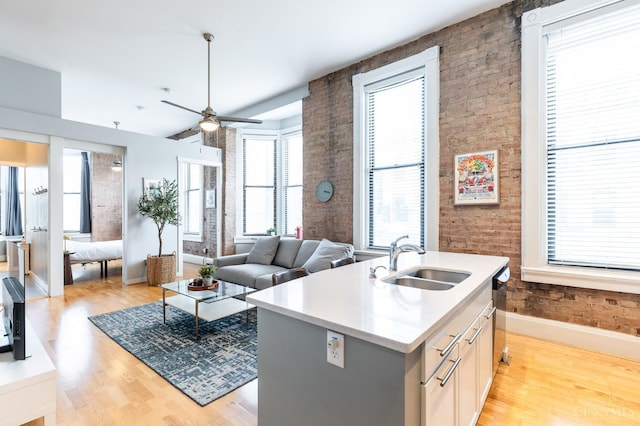1201 Vine St Unit C, Cincinnati, OH 45202 - kitchen featuring light wood finished floors, plenty of natural light, and brick wall