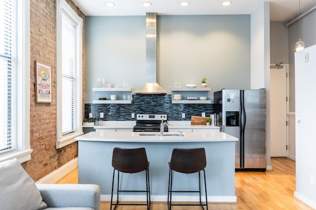 1201 Vine St Unit C, Cincinnati, OH 45202 - kitchen with appliances with stainless steel finishes, open shelves, light countertops, a center island with sink, and brick wall