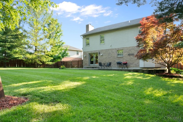 1662 W Kemper Rd, Springfield Twp, OH 45240 - rear view of property with a chimney and a patio area