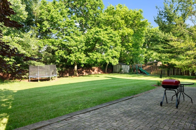 1662 W Kemper Rd, Springfield Twp, OH 45240 - fenced backyard with a trampoline, a storage shed, a playground, and a patio area