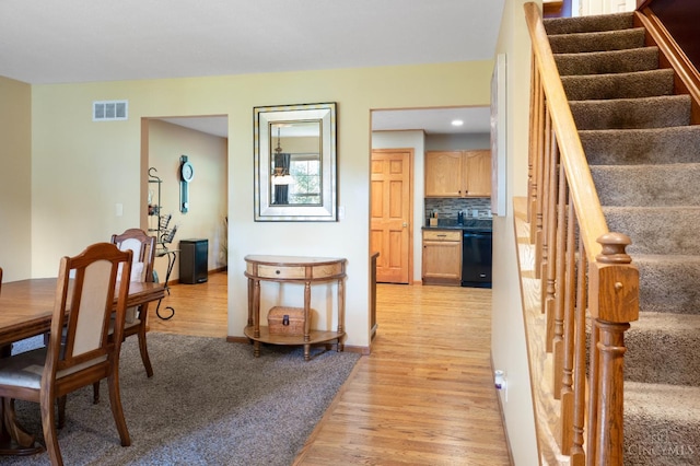 1662 W Kemper Rd, Springfield Twp, OH 45240 - dining area with light wood-style floors and stairs