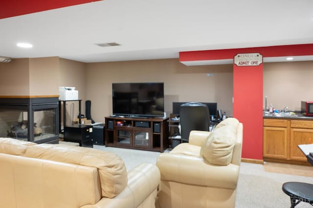 1662 W Kemper Rd, Springfield Twp, OH 45240 - living area featuring light colored carpet, wet bar, recessed lighting, and a multi sided fireplace