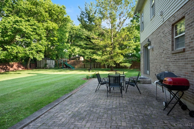 1662 W Kemper Rd, Springfield Twp, OH 45240 - fenced backyard with area for grilling, a shed, a playground, a patio area, and outdoor dining space
