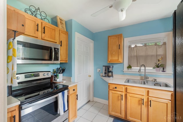 6579 Sherman Ave, Anderson Twp, OH 45230 - kitchen with stainless steel appliances, light tile patterned floors, light countertops, and ceiling fan