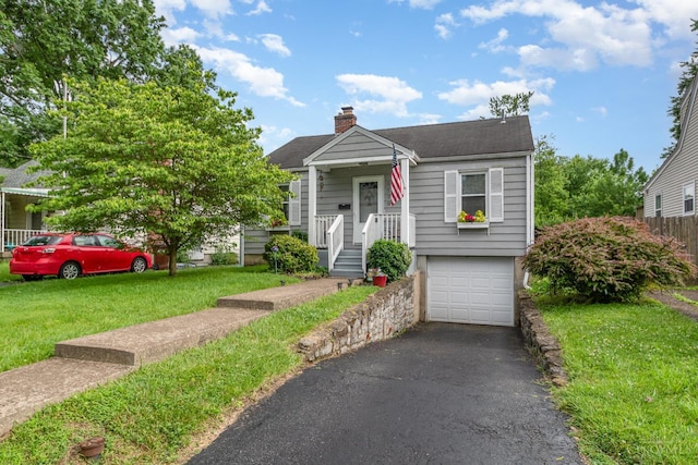 6579 Sherman Ave, Anderson Twp, OH 45230 - view of front of home featuring a chimney, an attached garage, a front lawn, asphalt driveway, and a shingled roof
