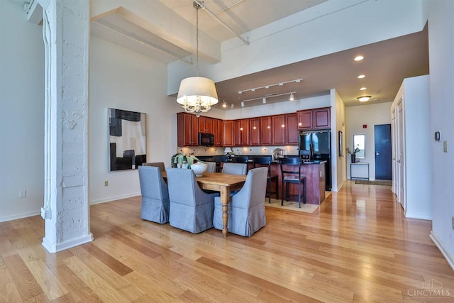 400 Pike St Unit 921, Cincinnati, OH 45202 - dining area featuring light wood-style floors, rail lighting, a chandelier, and beam ceiling