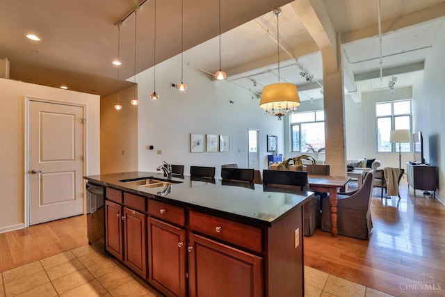 400 Pike St Unit 921, Cincinnati, OH 45202 - kitchen with rail lighting, dishwasher, light tile patterned floors, an island with sink, and recessed lighting