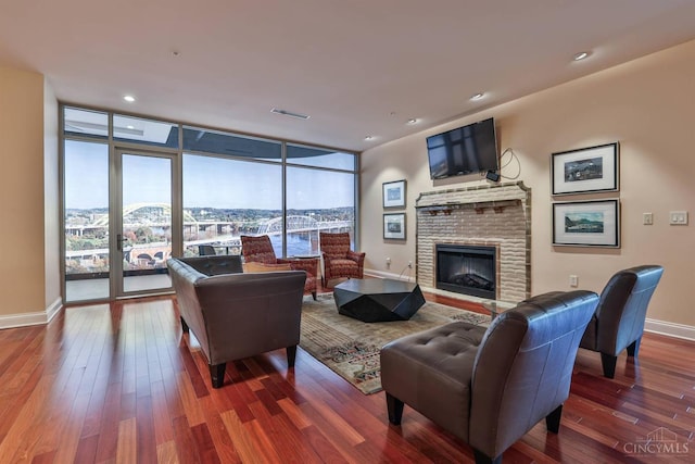 400 Pike St Unit 921, Cincinnati, OH 45202 - living area with plenty of natural light, floor to ceiling windows, hardwood / wood-style floors, a glass covered fireplace, and french doors