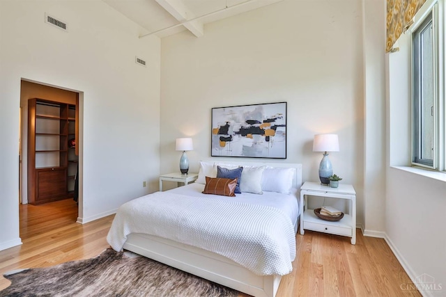 400 Pike St Unit 921, Cincinnati, OH 45202 - bedroom with light wood finished floors, beam ceiling, a walk in closet, and a high ceiling