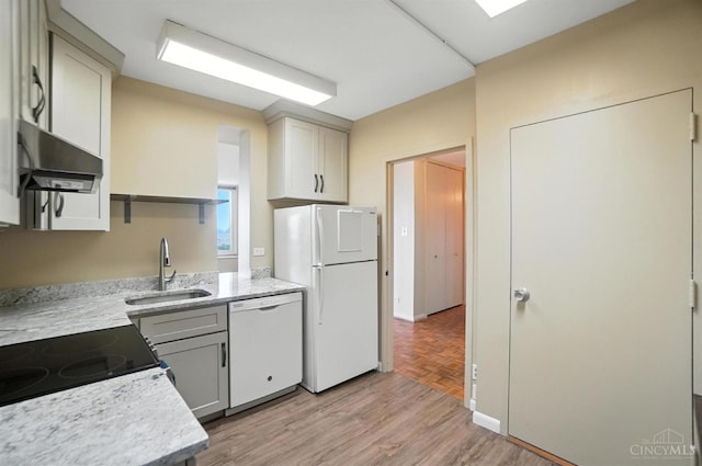 2401 Ingleside Ave Unit 8D, Cincinnati, OH 45206 - kitchen featuring white appliances, range hood, light wood-style floors, and light stone countertops