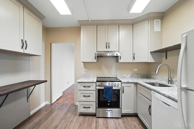 2401 Ingleside Ave Unit 8D, Cincinnati, OH 45206 - kitchen with white appliances, open shelves, under cabinet range hood, light wood-style floors, and light stone countertops