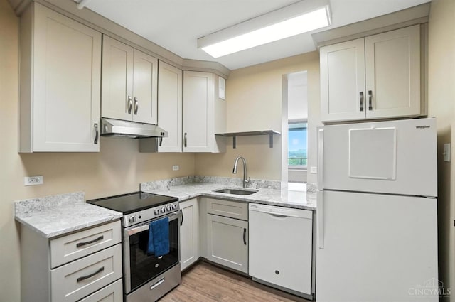 2401 Ingleside Ave Unit 8D, Cincinnati, OH 45206 - kitchen featuring white appliances, under cabinet range hood, light wood-style flooring, and light stone countertops