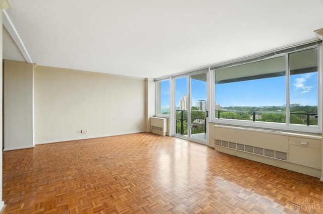 2401 Ingleside Ave Unit 8D, Cincinnati, OH 45206 - empty room featuring radiator, plenty of natural light, and expansive windows