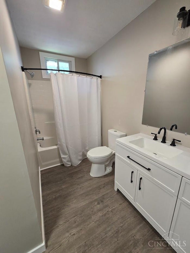 423 Howard St, Wilmington, OH 45177 - bathroom featuring vanity, wood finished floors, and shower / tub combo