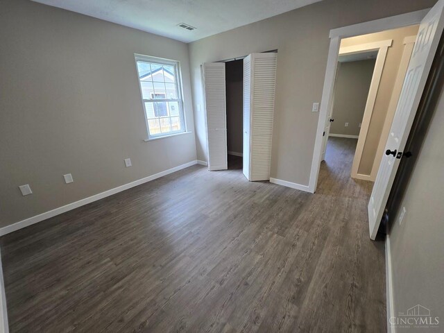 423 Howard St, Wilmington, OH 45177 - unfurnished bedroom with dark wood-style flooring and a closet