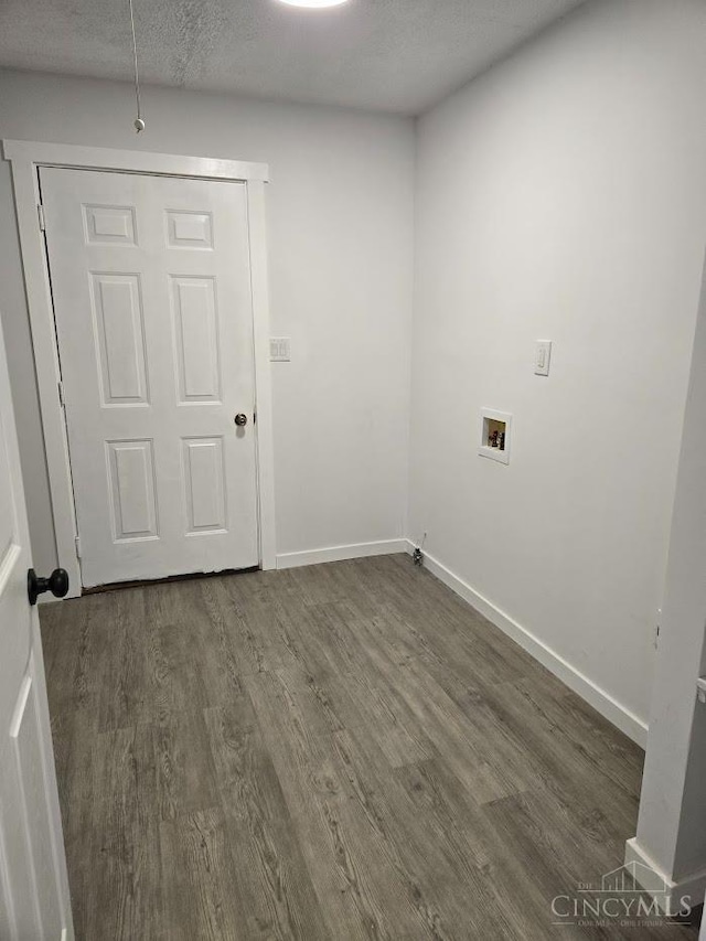 423 Howard St, Wilmington, OH 45177 - laundry area with dark wood finished floors, washer hookup, and a textured ceiling