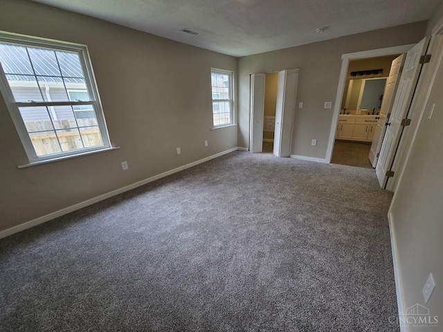 423 Howard St, Wilmington, OH 45177 - unfurnished bedroom with carpet flooring and connected bathroom