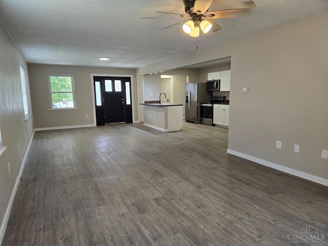 423 Howard St, Wilmington, OH 45177 - entryway with wood finished floors, ceiling fan, and a textured ceiling