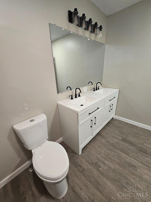423 Howard St, Wilmington, OH 45177 - bathroom featuring double vanity and wood finished floors