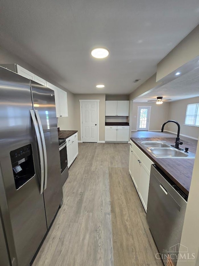 423 Howard St, Wilmington, OH 45177 - kitchen with stainless steel appliances, light wood-style flooring, white cabinetry, ceiling fan, and recessed lighting