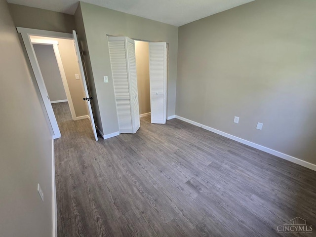 423 Howard St, Wilmington, OH 45177 - unfurnished bedroom with dark wood-style flooring and a closet