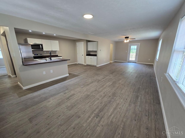 423 Howard St, Wilmington, OH 45177 - unfurnished living room featuring ceiling fan, dark wood-style floors, and recessed lighting