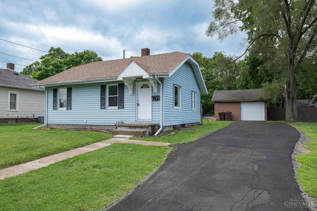 2456 Wilbraham Rd, Middletown, OH 45042 - bungalow-style home featuring a chimney, an outbuilding, a shingled roof, a front lawn, and asphalt driveway