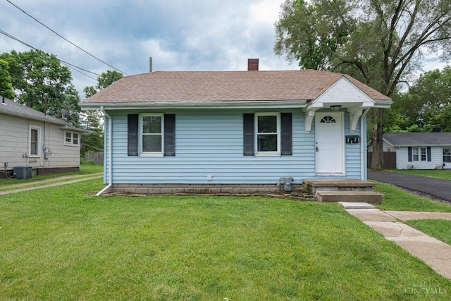 2456 Wilbraham Rd, Middletown, OH 45042 - view of front facade featuring a chimney, a front lawn, and roof with shingles