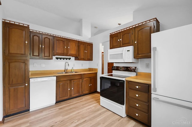 3235 Pebblebrook Ln Unit 35, Colerain Twp, OH 45251 - kitchen featuring white appliances, light countertops, and light wood-type flooring